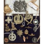 Military cap badges and pin badges from WW1 and WW2. Includes hallmarked silver 1917 S.S.A pin