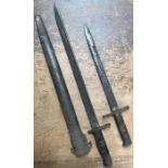 Two WW1 bayonets, one U.S Remington 1913 with scabbard with another bayonet makers mark worn (