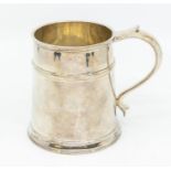 A George VI plain silver tapering tankard with upper section rib, scroll handle, hallmarked by