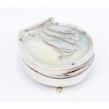A George V silver mounted mother-of-pearl shell shaped ring box, the cover applied with silver Art