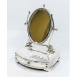 An Edwardian silver mounted dressing table mirror, oval mirror with central finial, fitted velvet