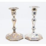 A pair of George II silver octagonal candlesticks with detachable drip pans, hallmarked by