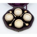 A set of four Victorian silver salts, cauldron shaped plain beaded rims, the bodies chased with