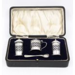 A George V silver three piece condiment set comprising salt, pepper & mustard pot, each with