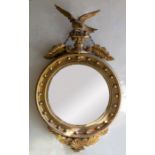 A Regency style giltwood and composition convex wall mirror, probably late19th century, with ball