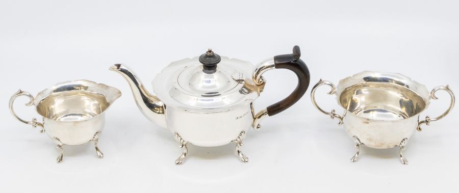 A late Victorian silver Bachelor three piece tea set, flared wavy rims above plain bodies on shell