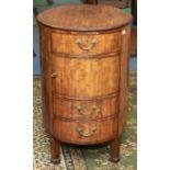 A George III mahogany oval commode cupboard, the slightly oversailing top above a single drawer,