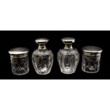 A matched four piece George V silver mounted and cut glass toilet set comprising two large bottles