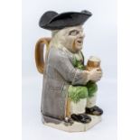 A Ralph Wood type Toby jug c.1790, his large jug of ale spilling over the side as it rests on his