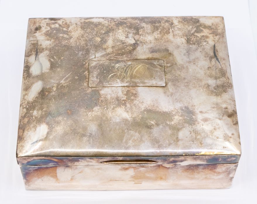 An early 20th Century plain silver large jewellery box (cigar box), the bombe cover engraved with