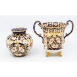 An early 20th Century Royal Crown Derby Old Imari two handled campana shaped vase, on gilt scroll