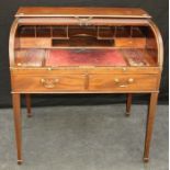An early 19th century mahogany tambour fronted writing desk, with fitted interior and adjustable