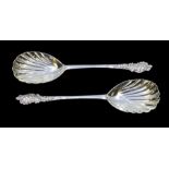 A pair of late Victorian silver serving spoons, shell bowls with ornate terminals, hallmarked by