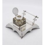 A George V silver combination inkstand and pen holder, plain shaped square body with wavy apron on