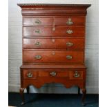 A George III oak chest on stand, circa 1780, dental pediment above a secret frieze drawer on two