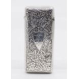 A Victorian silver cigar case, the body profusely engraved with ivy leaves, central shield shape