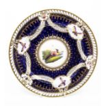An early 19th Century plate in the manner of Coalport, cobalt blue ground, the border decorated with