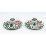 A pair of early 20th Century Wemyss chambersticks, wavy rims, the entire decorated with pink cabbage