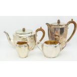 A George VI silver matched four piece tea service to include teapot, hot water or coffee pot,