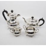 A George V plain silver four piece tea service to include: teapot, hot water jug, sugar bowl and