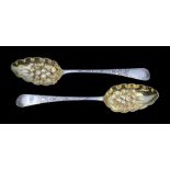 A matched pair of silver and parcel gilt berry spoons, engraved floral decoration, hallmarked