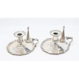A pair of early Georgian style silver chamber / candle sticks and snuffers, the bases with pie crust
