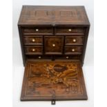 A Charles II marquetry cabinet, the hinged door inlaid with birds opening down to reveal a set of