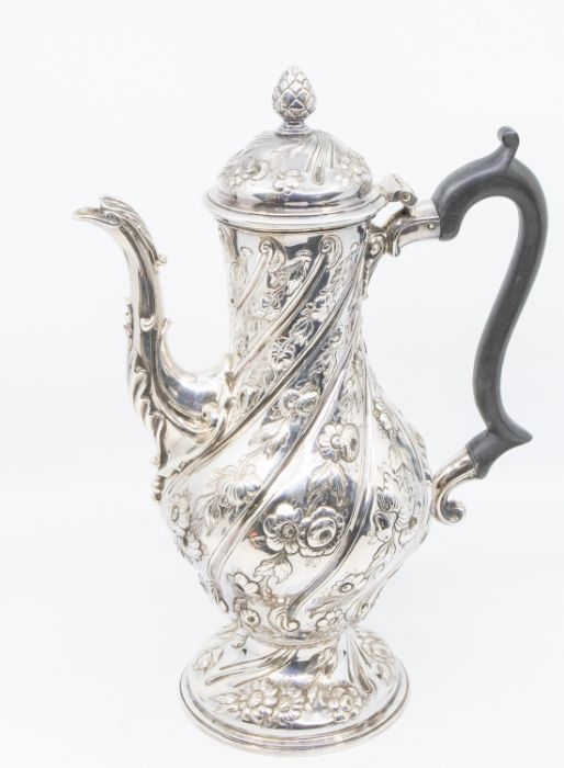 A George III silver baluster shaped coffee pot, the body wyvern fluted, chased and embossed with