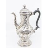 A George III silver baluster shaped coffee pot, the body wyvern fluted, chased and embossed with
