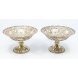 A pair of late Victorian silver tazze / bowls, shaped circular with openwork scrolling borders,