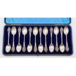 A set of twelve Victorian silver teaspoons, ornate openwork handles, hallmarked by William Comyns,