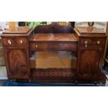 An early 19th Century Empire period mahogany pedestal sideboard, circa 1820, the top with a shaped