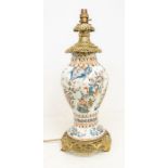 An 18th century Delft ware tin glazed wrythen vase, painted with fanciful birds and flowers,
