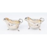 A pair of Georgian style sauce boats, plain bodies with wavy rim, S-scroll handle with acanthus