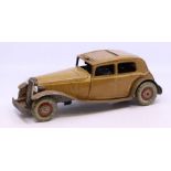 Tinplate: A tinplate, clockwork, beige saloon car, marked 'Made in England', possibly Mettoy,