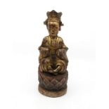 A Chinese gilt carved wood and painted figure of a court official, Ming Dynasty, seated wearing