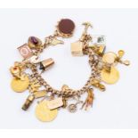 A 9ct gold charm bracelet with various 9ct gold and yellow metal charms including bloodstone