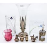 A silver three piece cruet; a silver pepperette; glass bottle with EP pierced sleeve; a plated and
