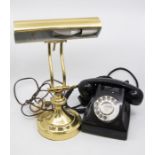 A brass desk lamp, and a 1970's telephone