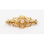A diamond and gold brooch, comprising a claw set old European cut diamond set to the centre,
