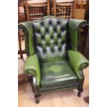 A green wing back leather fireside Chesterfield smokers chair