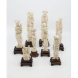 Eight assorted carved ivoru okimono, on hardwood stands (8)