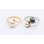 A Continental white gold and black and white cultured pearl crossover ring, size P, along with a