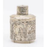 A Dutch silver oval shaped tea canister and cover, the body chased with pastoral scenes, on four