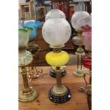 Art Nouveau oil lamp with brass and yellow vaseline glass body on black stand with etched glass