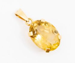 A citrine and unmarked yellow metal  pendant, set with an oval cut citrine approx. 19 x 14mm, claw