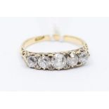 A diamond and 18ct gold five stone ring, comprising a row of old cut graduated diamonds, with