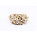 A diamond and 9ct gold dress ring, comprising a cross hatch pattern grain set with champagne round