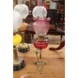 Late 19th Century tripod brass and ruby glass oil lamp with brass carry handle ad ruby etched