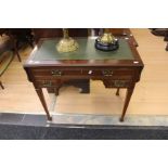 An Edwardian mahogany small ladies' desk;  with fold down sides, three drawers and green leather